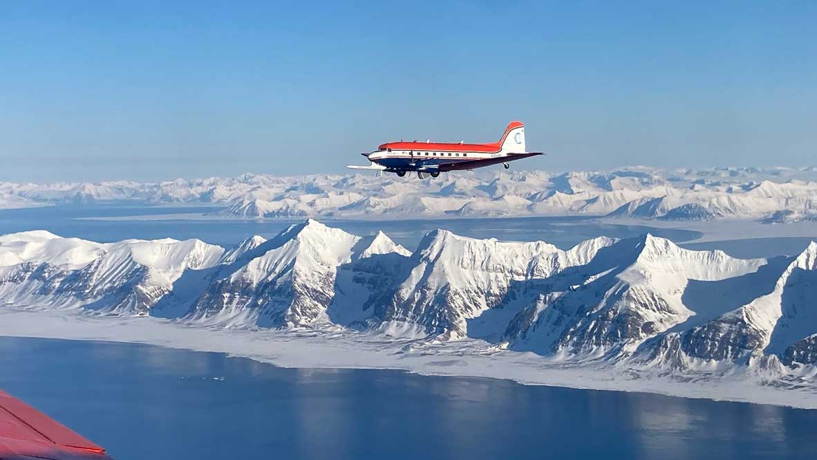 Polar 5 off the coast of Longyearbyen from the window of Polar 6